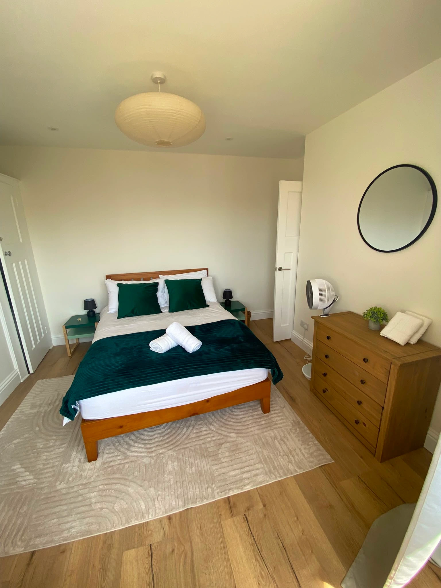 Professionally cleaned double bedroom with green bedding